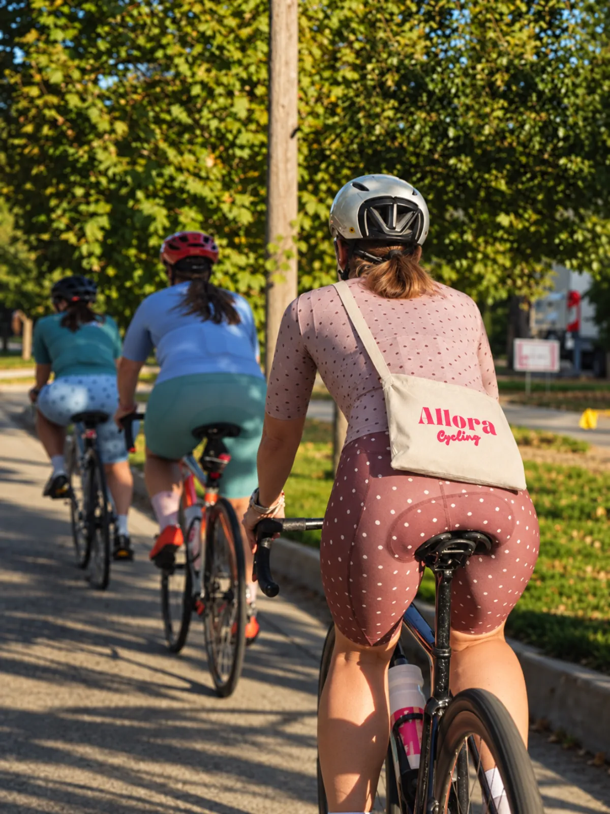 A rider wearing the Allora musette bag over her back on a group ride